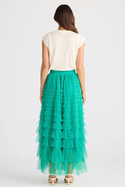 A model wearing the Chance Skirt in colour Jade (Green), from the back