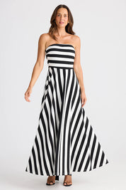 A model wearing the Thandie Strapless Dress in colour Blackwhit, from the front, showing the whole outfit