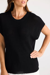 A model wearing the Limo Knit Tee in colour Black (Black), from the front, cropped image