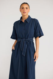 Model Genericm wearing size sample of the Leo Dress - Navy in colour Navy, in a cropped view