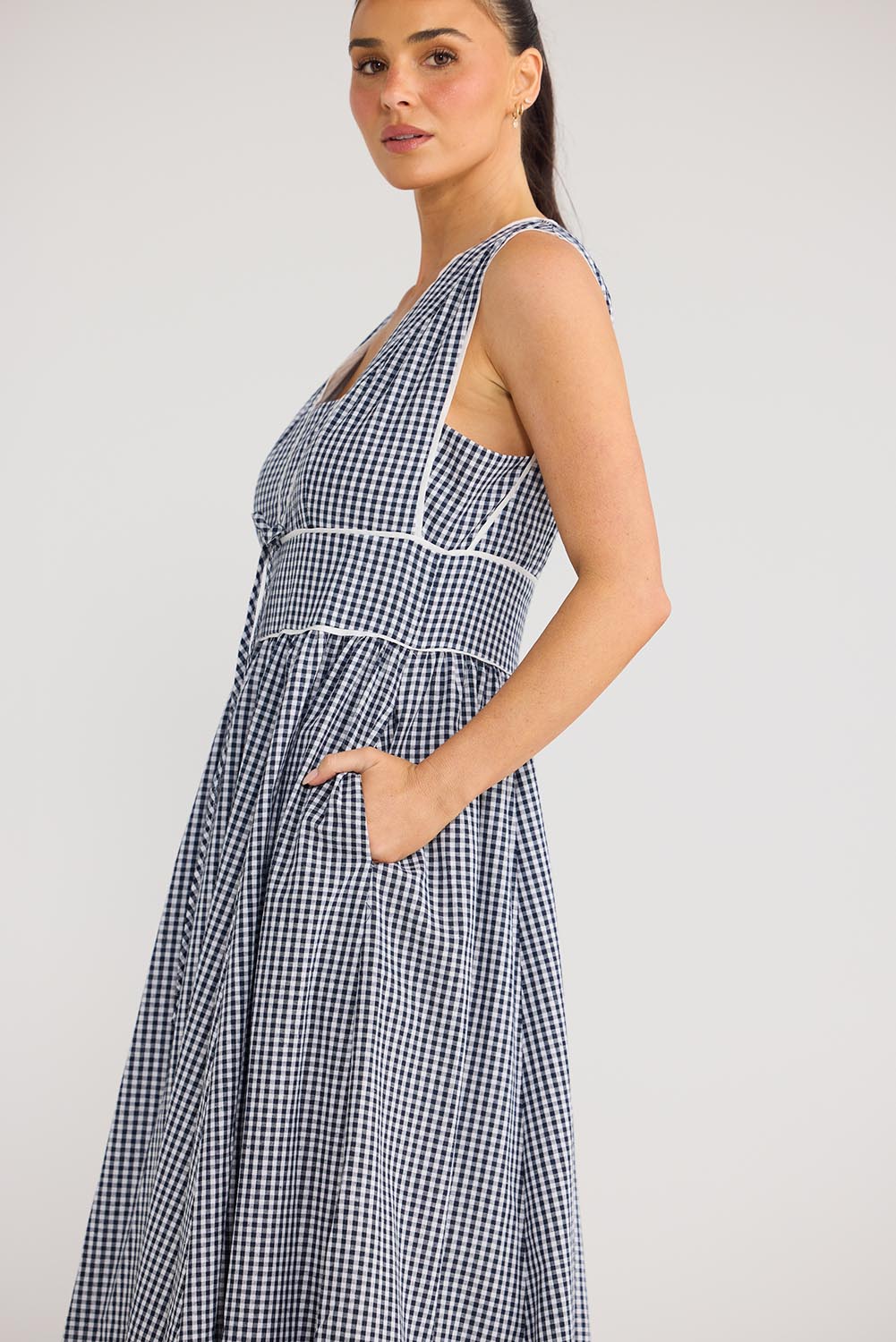 Model Genericm wearing size sample of the Pimms Dress - Navycheck in colour Navycheck, from an angle