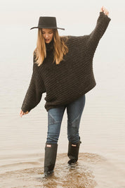 Model Katie wearing the Saffron Knit in colour Black (Black), from the front, showing the whole outfit