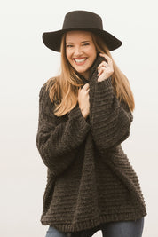 Model Katie wearing the Saffron Knit in colour Black (Black), from the front, showing the whole outfit