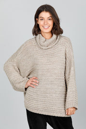 A model wearing the Saffron Knit in colour Cement (Grey), from the front, cropped image