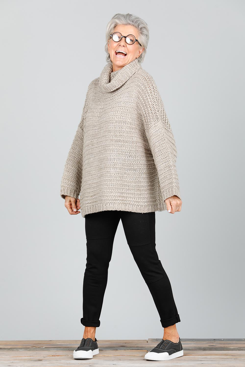 A model wearing the Saffron Knit in colour Cement (Grey), from the front, showing the whole outfit