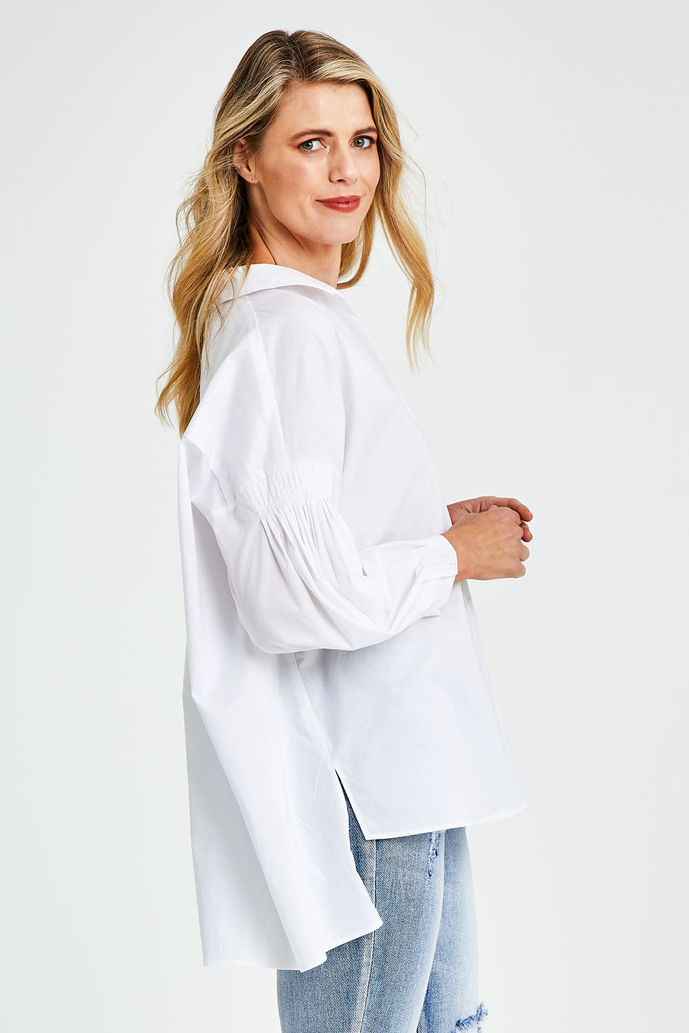 Model Kelly wearing size S of The Duchess Shirt in colour White (White), from the back