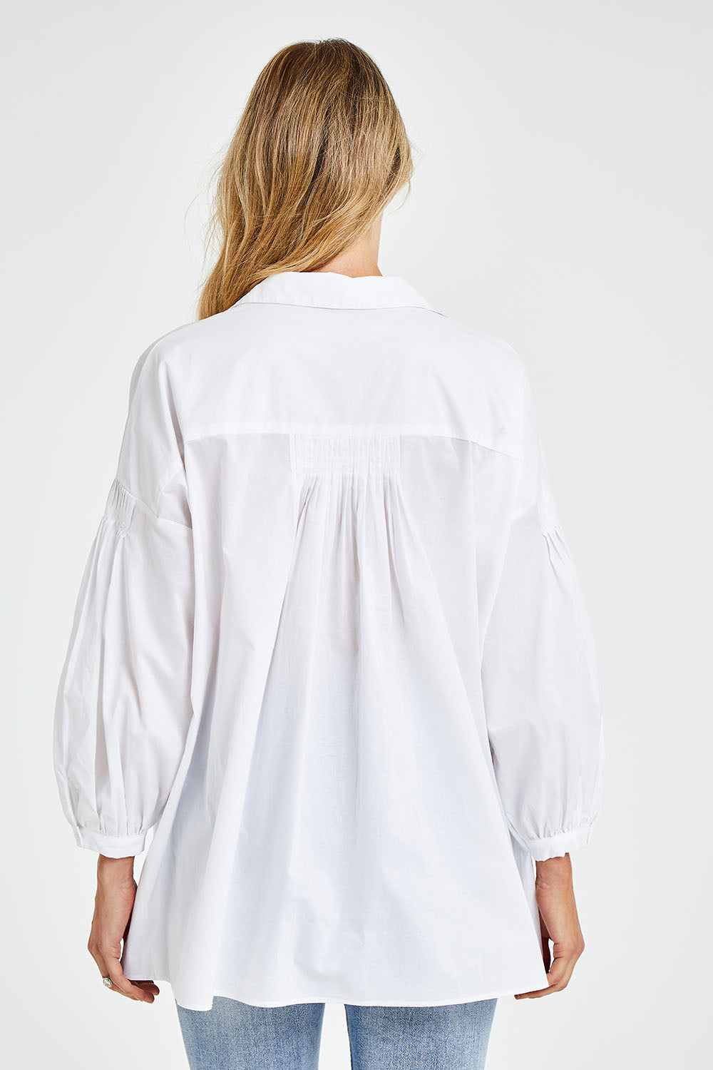 Model Kelly wearing size S of The Duchess Shirt in colour White (White), from the back