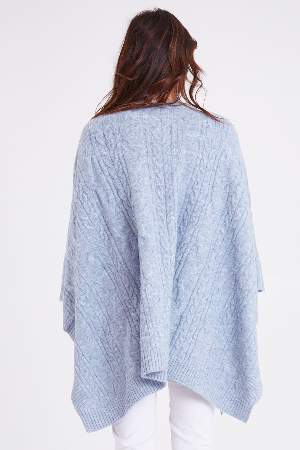 Model Madeline wearing the Marnie Cable Knit Poncho in colour Iceblue (Blue), from the back