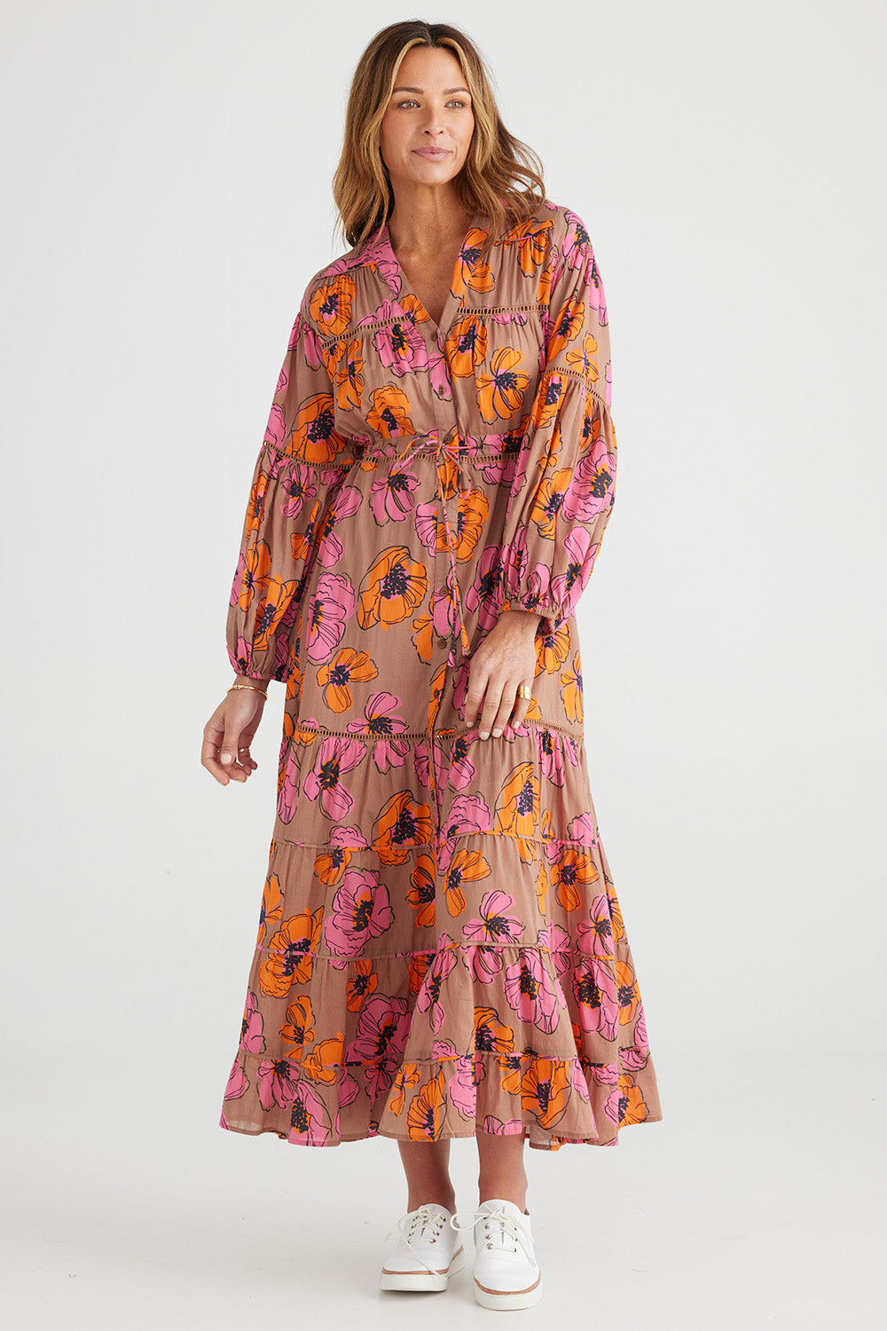 A model wearing the Gertie Dress in colour Bromley, from the front, showing the whole outfit