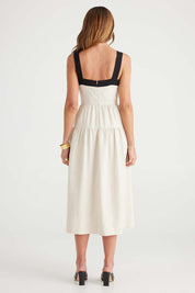 A model wearing the Jolie Dress in colour Naturalblk, from the back