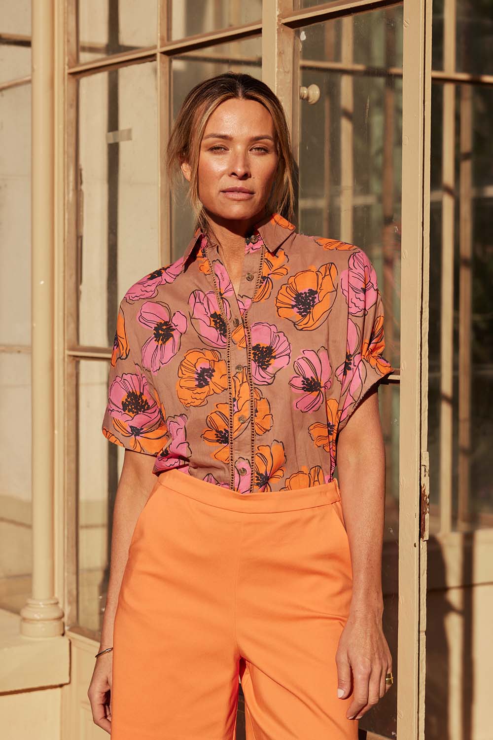 A model wearing the Alice Shirt in colour Bromley, from the front, showing the whole outfit