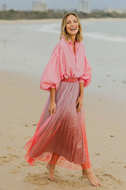 Model Riina wearing size S of the West End Skirt in colour Pinkred (Pink), from the front, showing the whole outfit