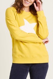 A model wearing the Star Crew Neck Cotton Sweatshirt in colour Mustard, from the front, cropped image