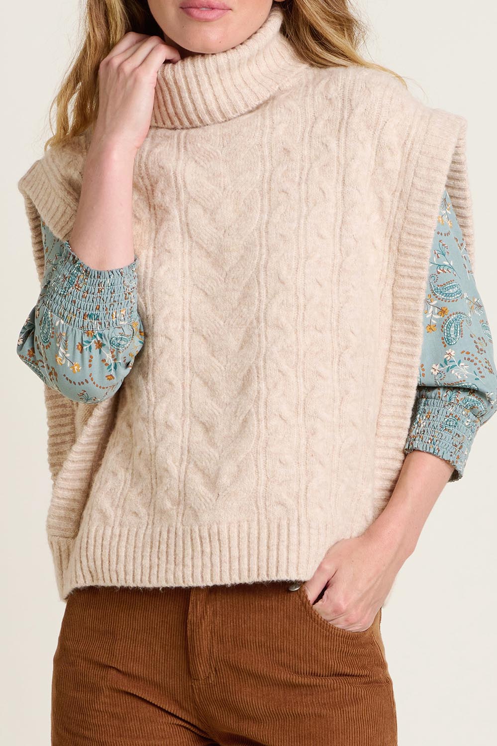A model wearing the Cable Knitted Vest in colour Natural, from the front, cropped image