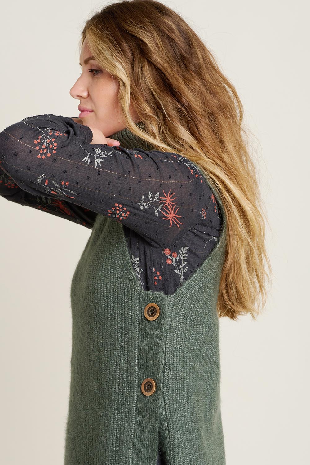 A model wearing the Button Side Knitted Vest in colour Khaki (Green), from the front, cropped image