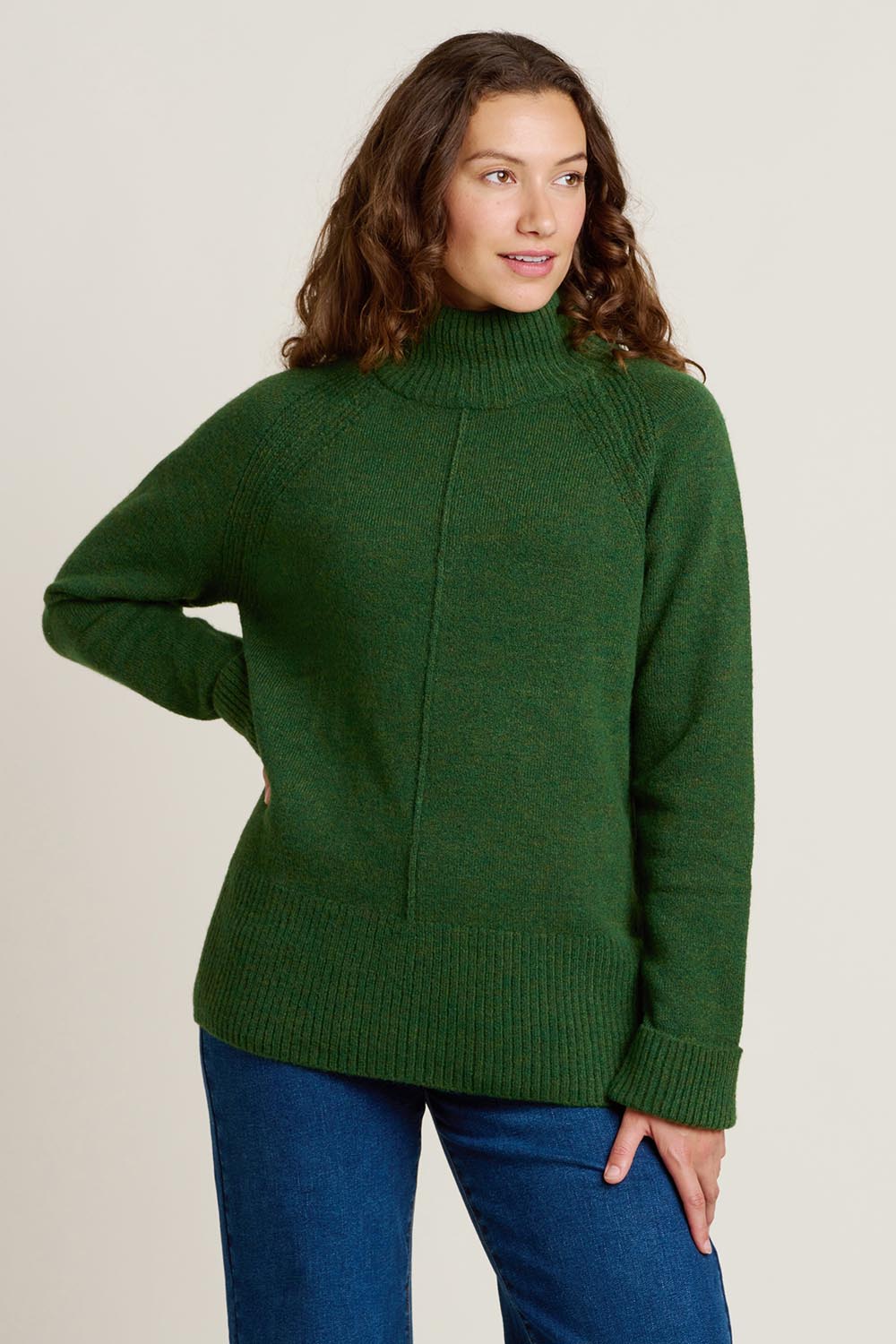 A model wearing the Forest Knitted Roll Neck Jumper in colour Green (Green), from the front, cropped image
