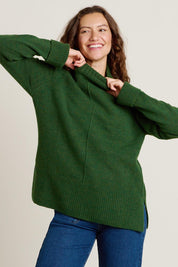 A model wearing the Forest Knitted Roll Neck Jumper in colour Green (Green), from the front, cropped image
