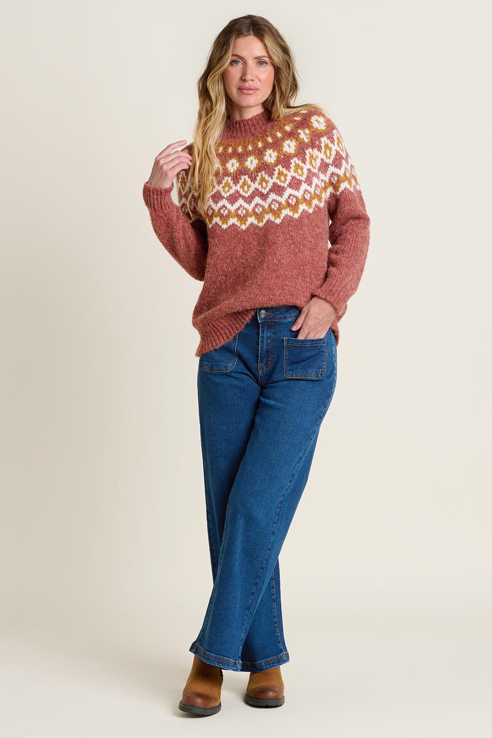 A model wearing the Chunky Knitted Fair Isle Jumper in colour Rust, from the front, showing the whole outfit