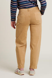 A model wearing the Barrel Leg Trousers in colour Natural, from the back
