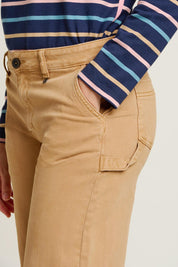 A model wearing the Barrel Leg Trousers in colour Natural, from the front, cropped image