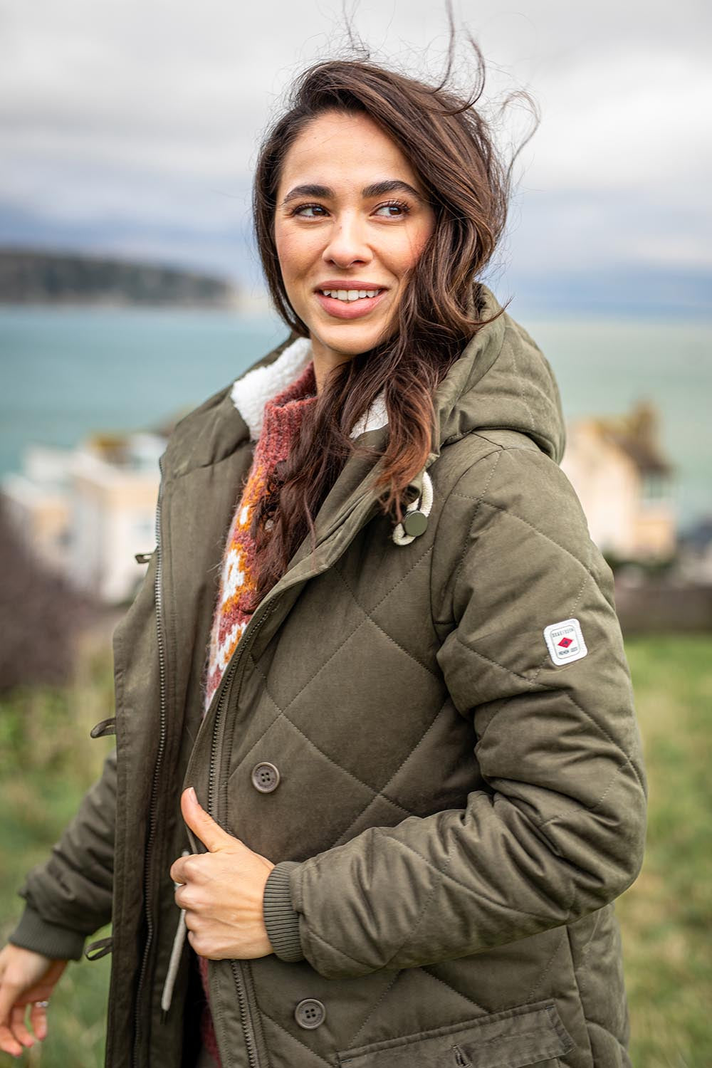 A model wearing the Bradstock Hooded Parka Jacket in colour Khaki (Green), from the front, showing the whole outfit