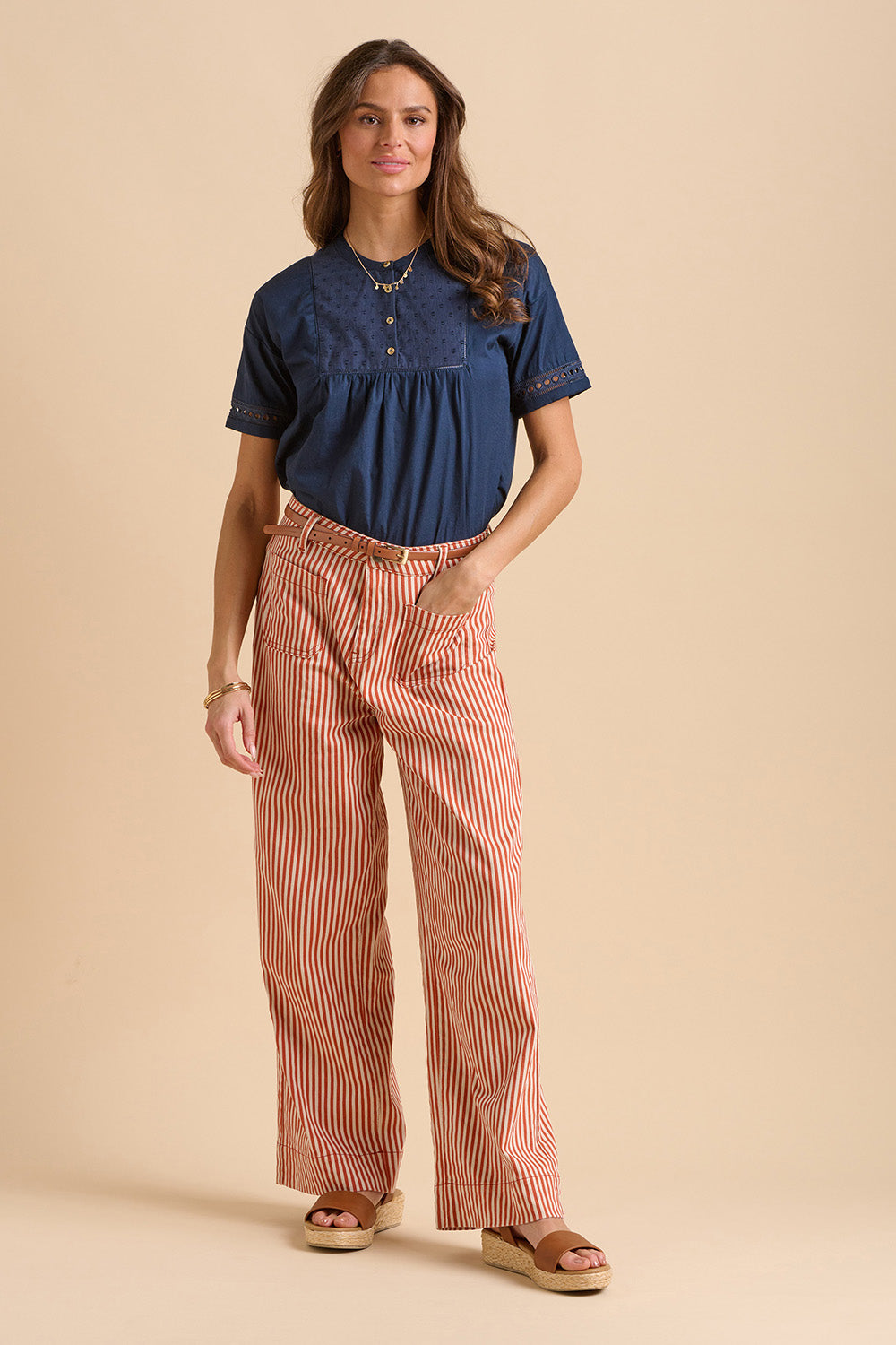 A model wearing the Stripe Straight Leg Jeans in colour Redwhite, from the front, showing the whole outfit