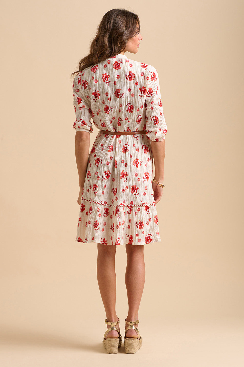 A model wearing the Fan Floral Cotton Knee Length Dress in colour Whitered, from the back