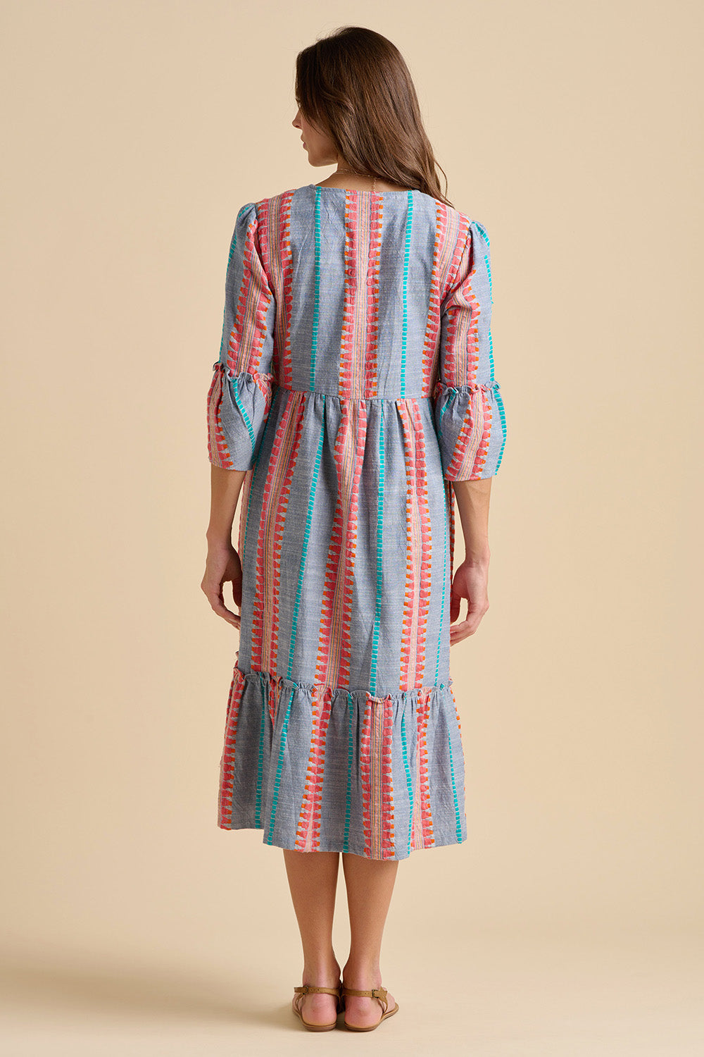 A model wearing the Shore Cotton Midi Dress in colour Bluered, from the back