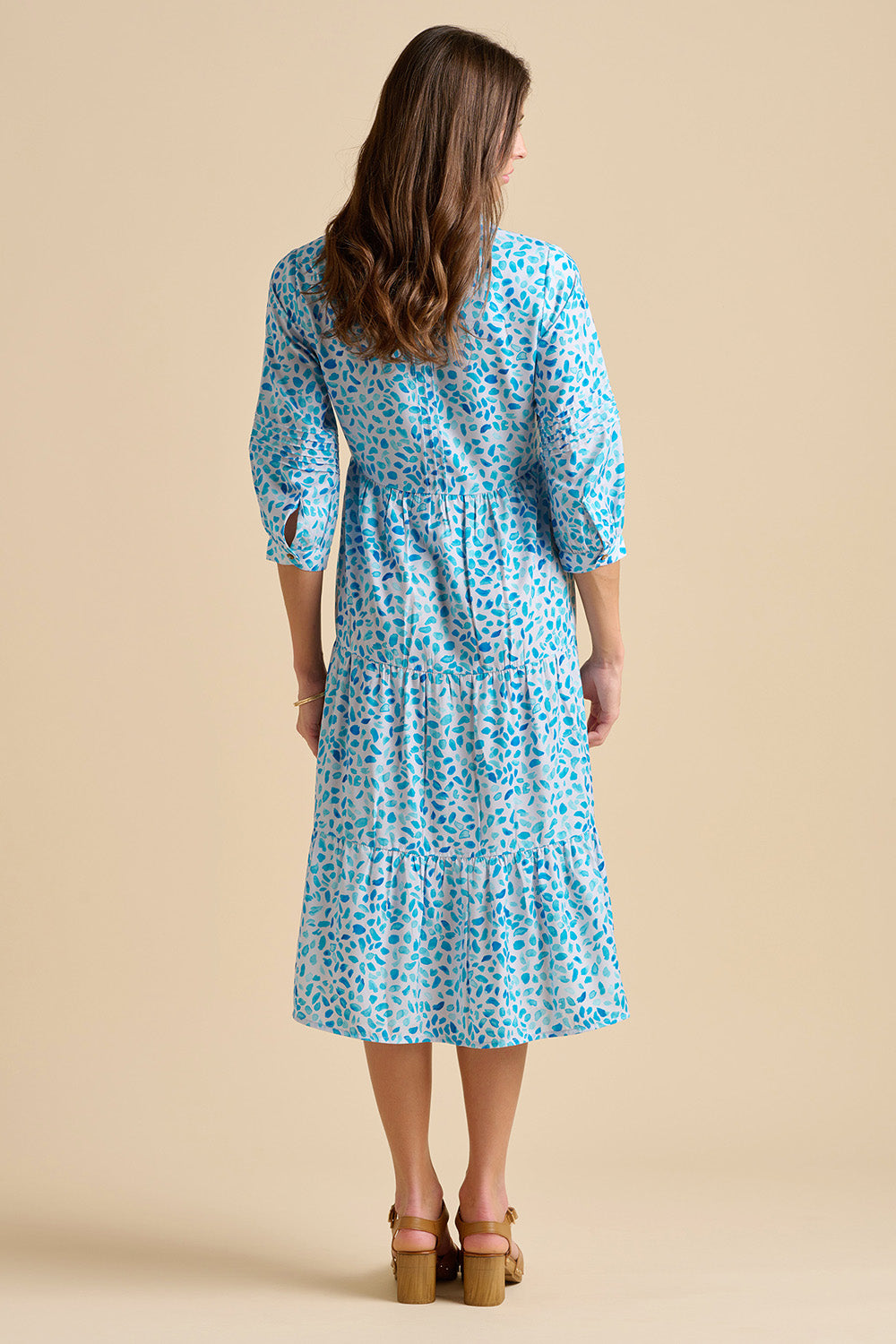 A model wearing the Sea Glitter Midi Dress in colour Blue (Blue), from the back