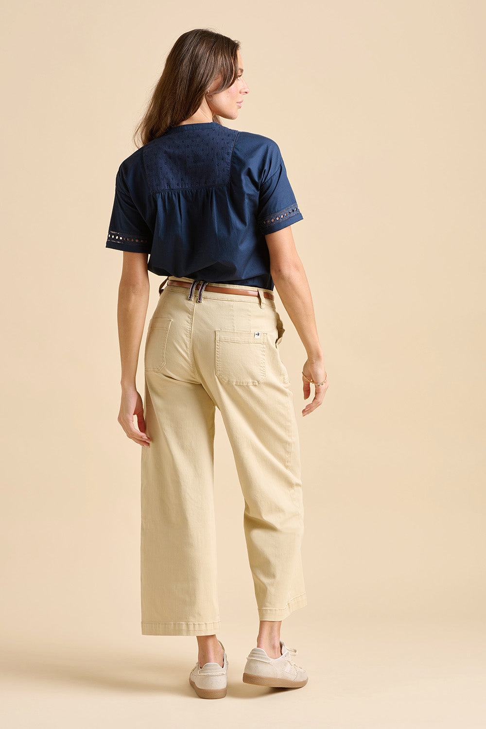 A model wearing the Quay Cotton Blouse in colour Navy (Blue), from the back