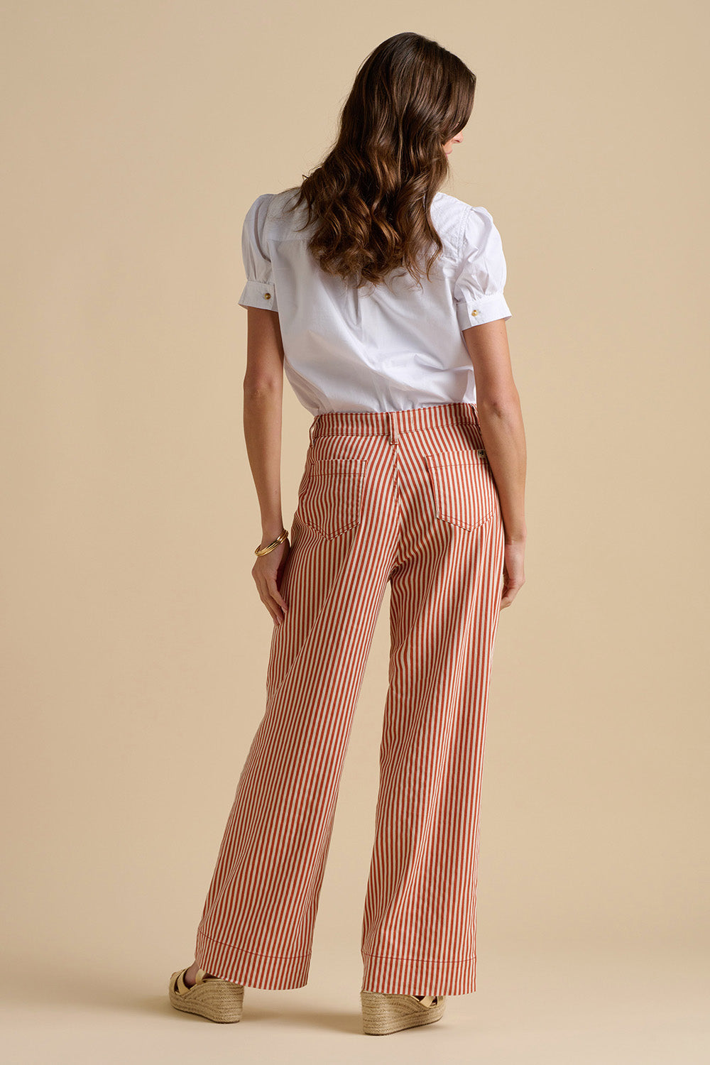 A model wearing the Cowrie Cotton Blouse in colour White (White), from the back