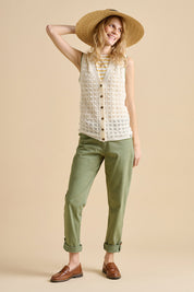 A model wearing the Pointelle Knitted Cotton Button Tank in colour Ceam, from the front, showing the whole outfit