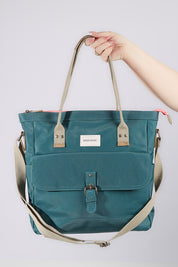 A model wearing size OneSize of the Sage Shopper in colour Sage (Blue), from the front, showing the whole outfit