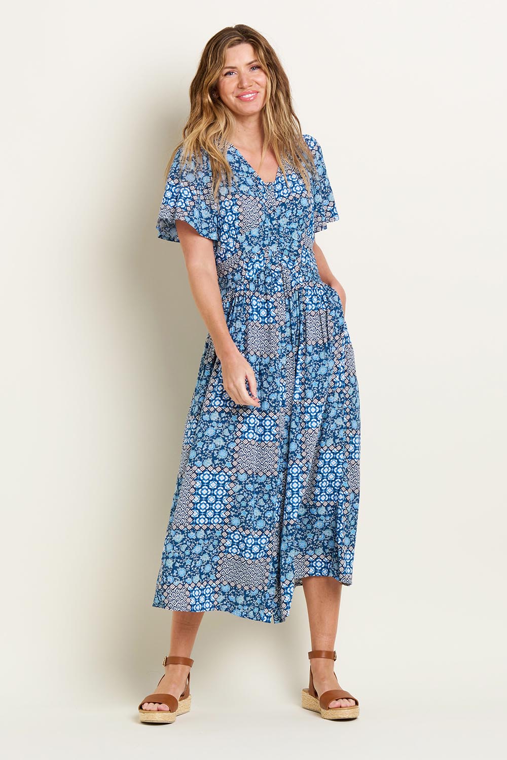 A model wearing the Folk Floral Patchwork Dress in colour Blue (Blue), from the front, showing the whole outfit