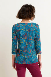 A model wearing the Uma Floral Paisley Tee in colour Floral (Green), from the back