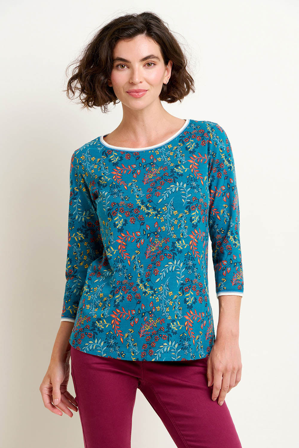 A model wearing the Uma Floral Paisley Tee in colour Floral (Green), from the front, cropped image