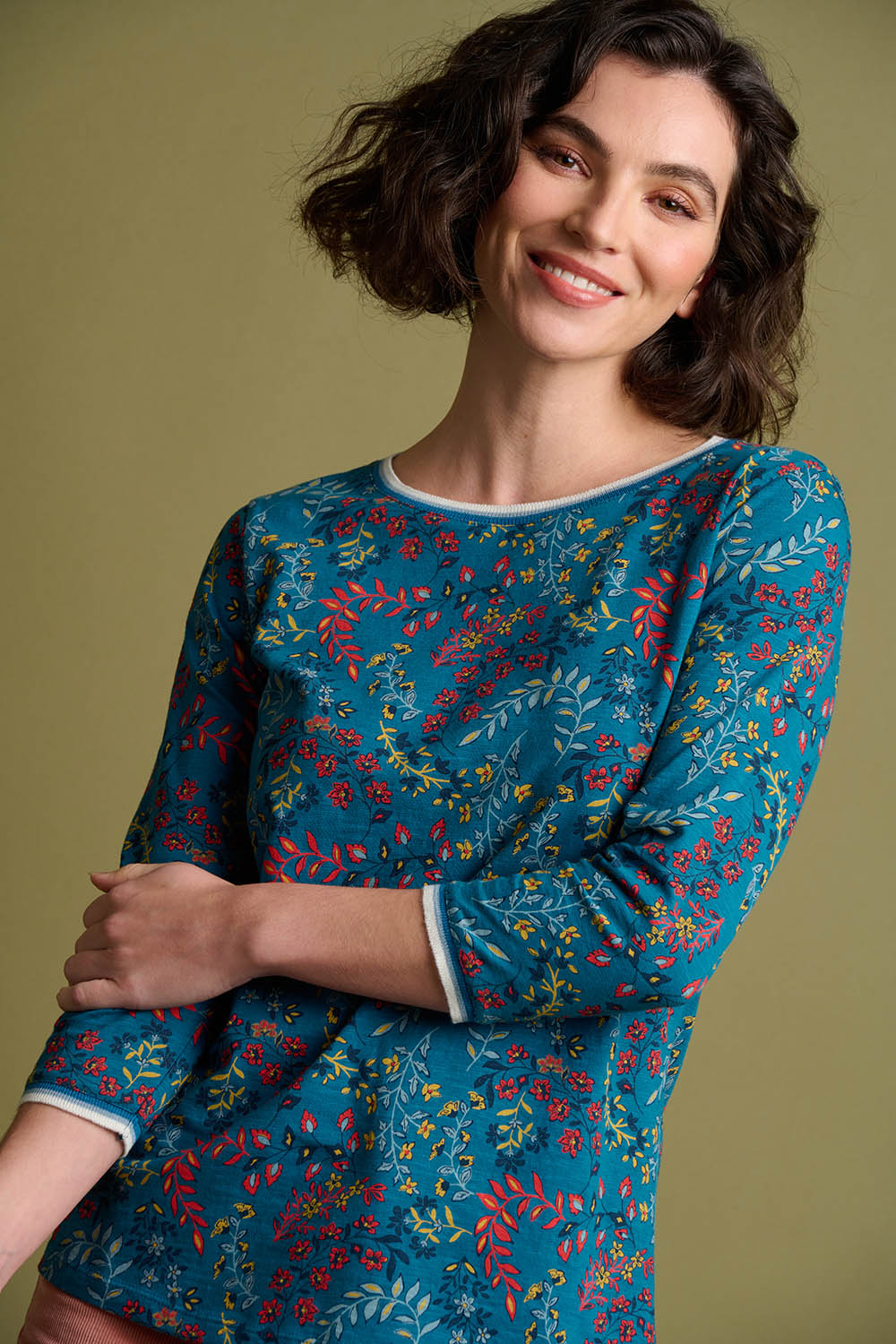 A model wearing the Uma Floral Paisley Tee in colour Floral (Green), from the front, showing the whole outfit