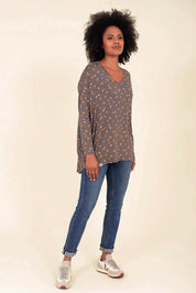 A model wearing the Dotty Loose Fit L/S Top in colour Navy (Blue), from the front, showing the whole outfit