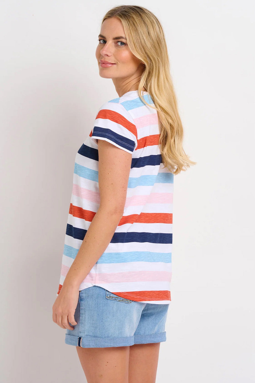 A model wearing the Anna Stripe Tee in colour Multi (Blue), from the back