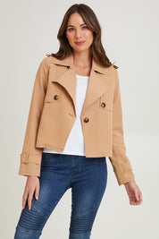 Model Madeline wearing size S of the Cropped Trench Jacket in colour Tan, from the front, cropped image
