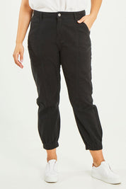 Model Terri-Leigh wearing size 14 of the Sara Cuffed Jean in colour Black (Black), from the front, cropped image