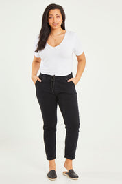 Model Terri-Leigh wearing size 14 of the Angela Jogger Jean in colour Black (Black), from the front, showing the whole outfit