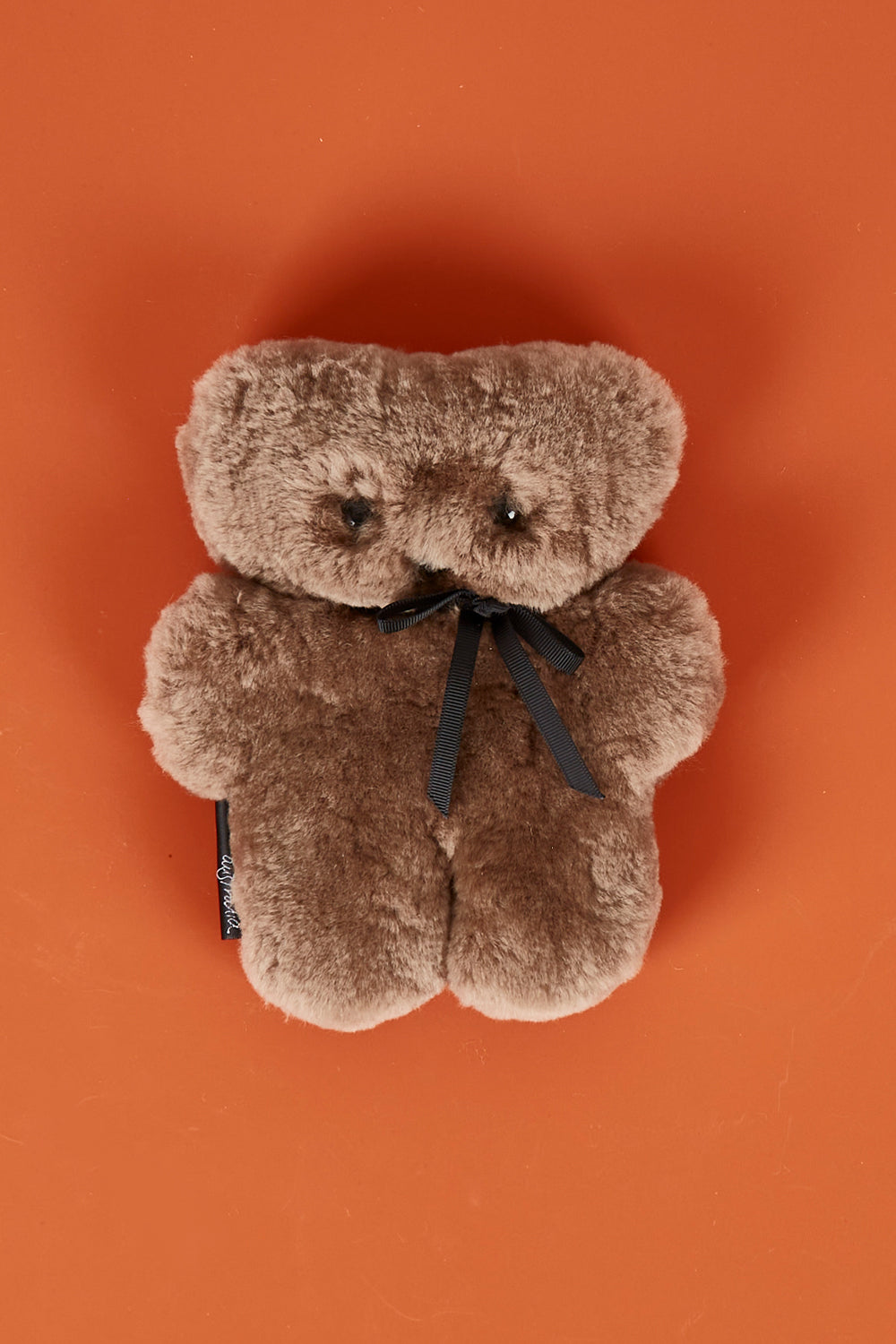 A model wearing the Baby Flatout Bear in colour Chocolate, from the front, showing the whole outfit
