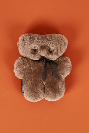 A model wearing the Baby Flatout Bear in colour Chocolate, from the front, showing the whole outfit