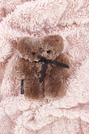 A model wearing the Baby Flatout Bear in colour Chocolate, from the front, showing the whole outfit
