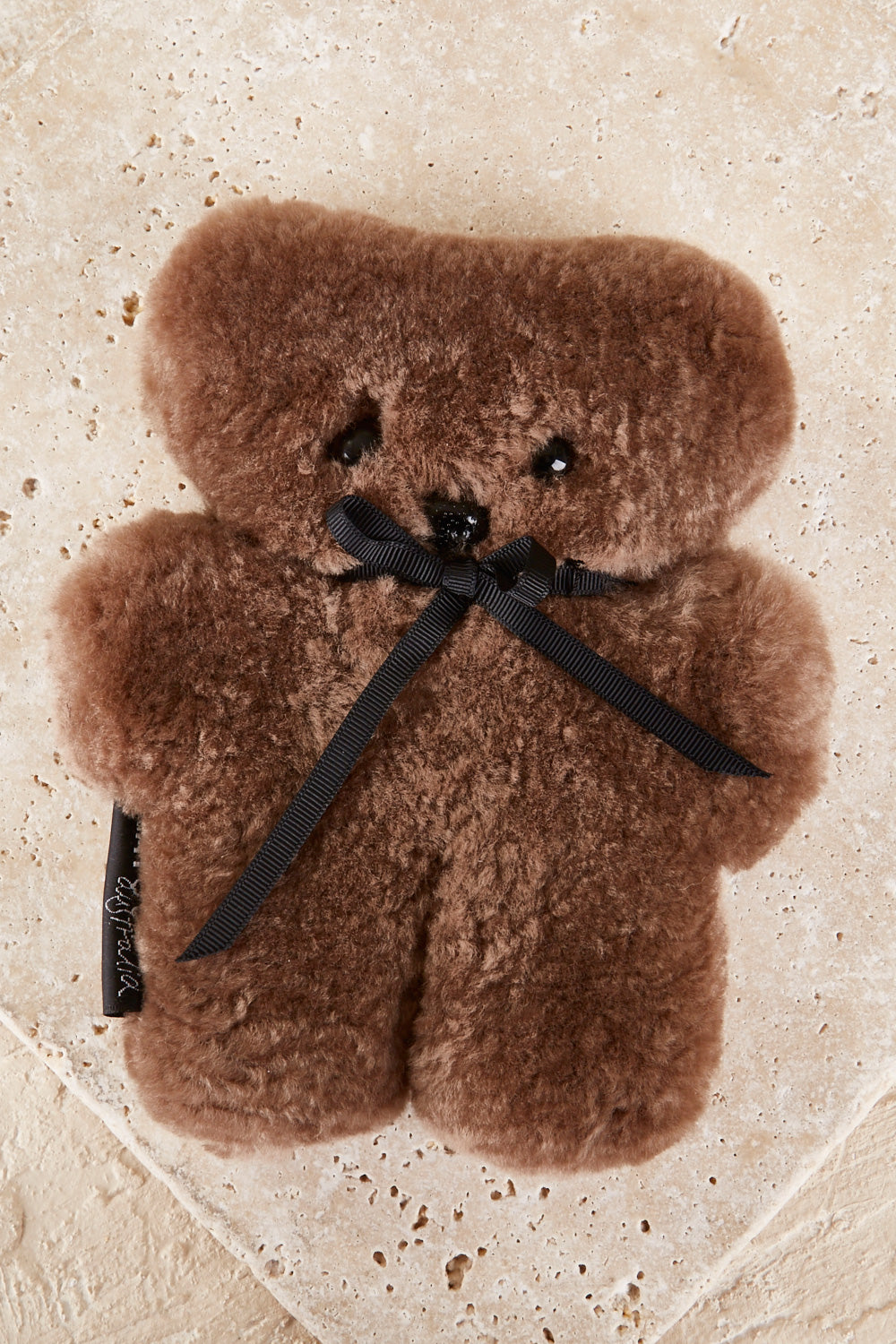 A model wearing the Baby Flatout Bear in colour Chocolate, from the front, showing the whole outfit