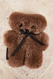 A model wearing the Baby Flatout Bear in colour Chocolate, from the front, showing the whole outfit