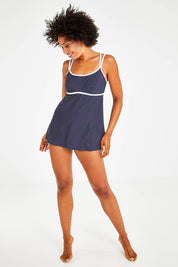 Model Olivia wearing size 12 of the Underwire Swim Dress in colour NavyWhite (Blue), from the front, showing the whole outfit