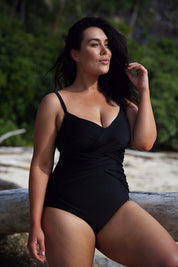 A model wearing the Criss Cross One Piece in colour Black (Black), from the front, showing the whole outfit