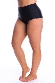 A model wearing the High Waisted Pants in colour Black (Black), from the front, showing the whole outfit